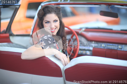 Image of Lovely Woman Posing and and Around a Vintage Car