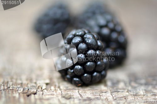Image of Ripe blackberry on a wooden background