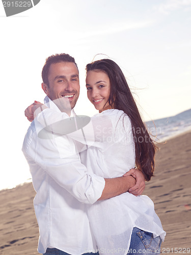 Image of young couple  on beach have fun