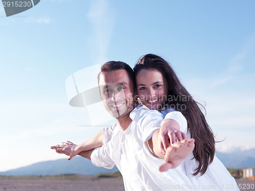Image of young couple  on beach have fun
