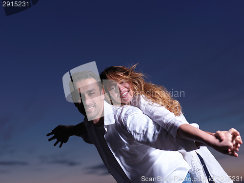 Image of young couple  on beach have fun