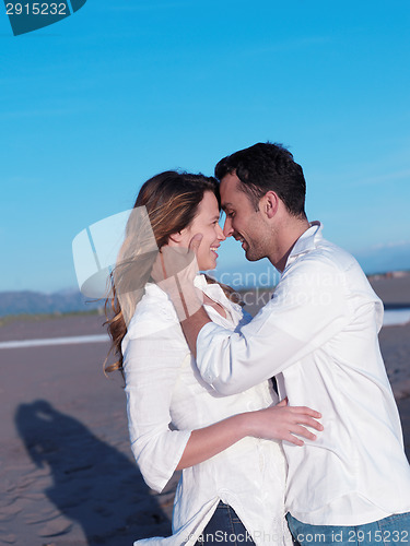 Image of young couple  on beach have fun