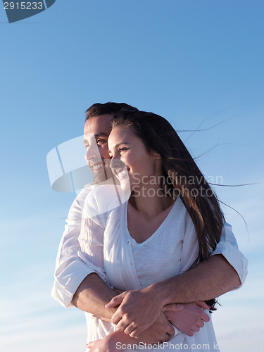 Image of young couple  on beach have fun