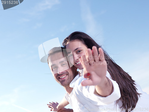 Image of young couple  on beach have fun