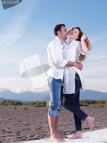 Image of young couple  on beach have fun