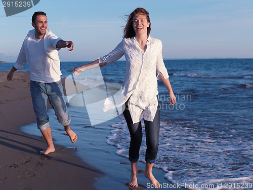 Image of young couple  on beach have fun