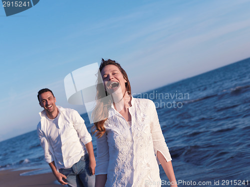 Image of young couple  on beach have fun