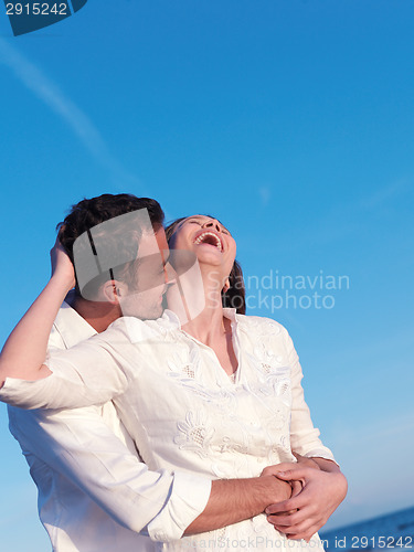 Image of young couple  on beach have fun
