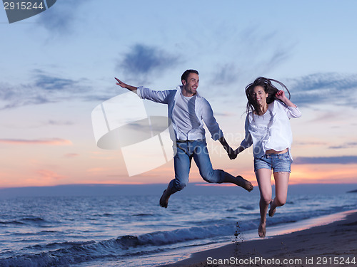 Image of young couple  on beach have fun