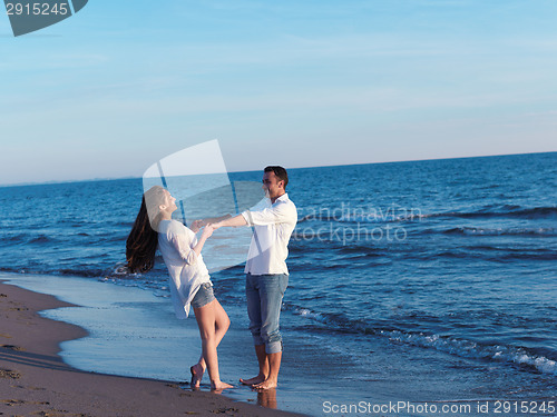 Image of young couple  on beach have fun
