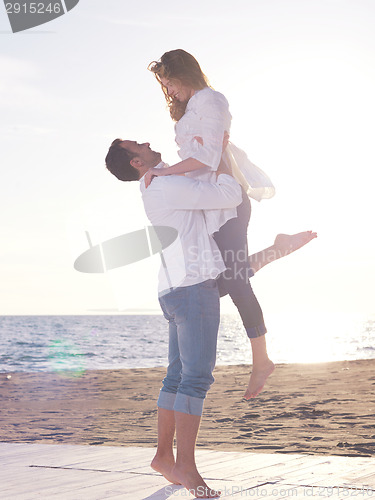 Image of young couple  on beach have fun