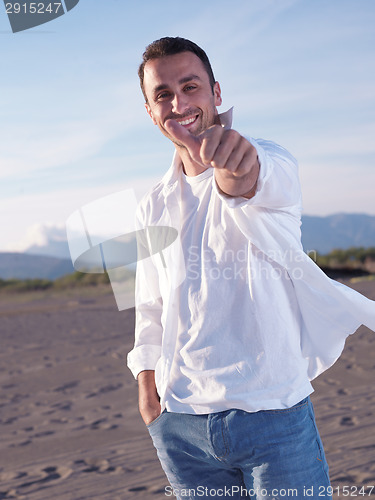 Image of young couple  on beach have fun