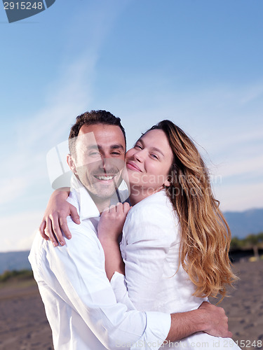 Image of young couple  on beach have fun