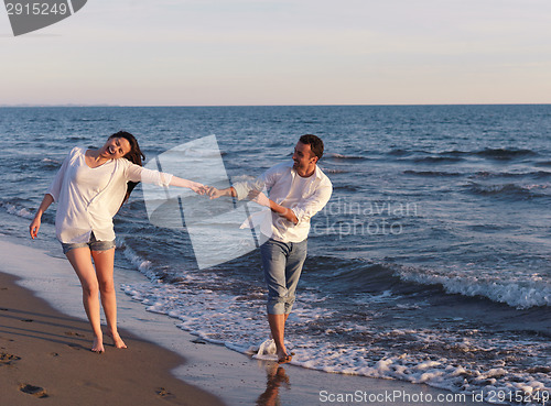 Image of young couple  on beach have fun