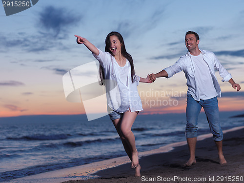 Image of young couple  on beach have fun