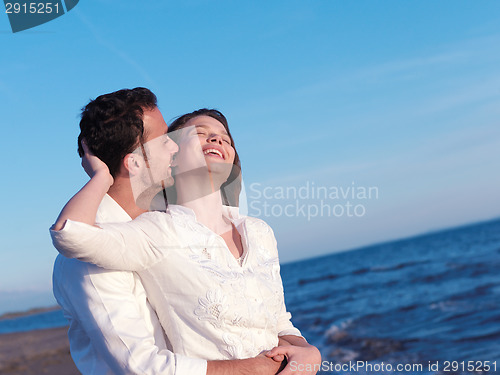 Image of young couple  on beach have fun