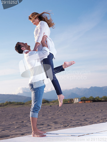 Image of young couple  on beach have fun