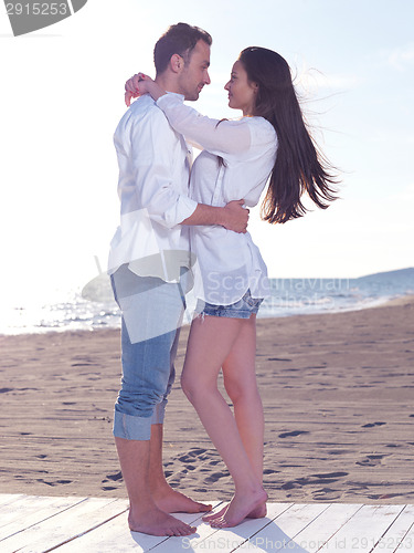 Image of young couple  on beach have fun