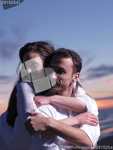 Image of young couple  on beach have fun