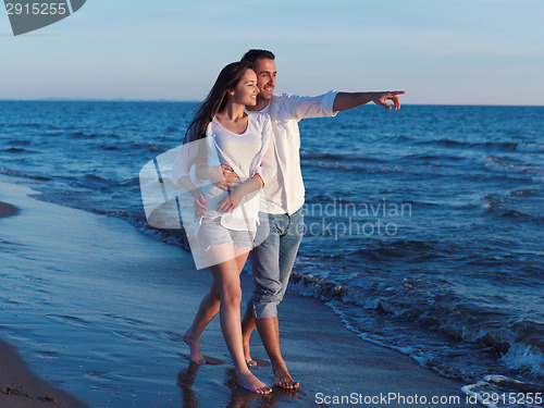 Image of young couple  on beach have fun