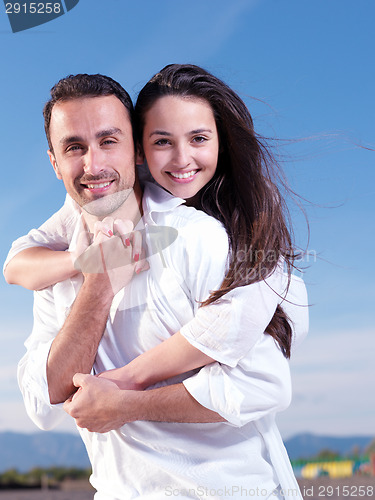 Image of young couple  on beach have fun