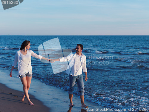 Image of young couple  on beach have fun