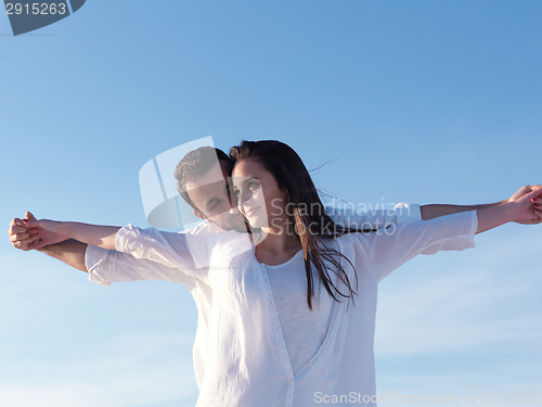 Image of young couple  on beach have fun