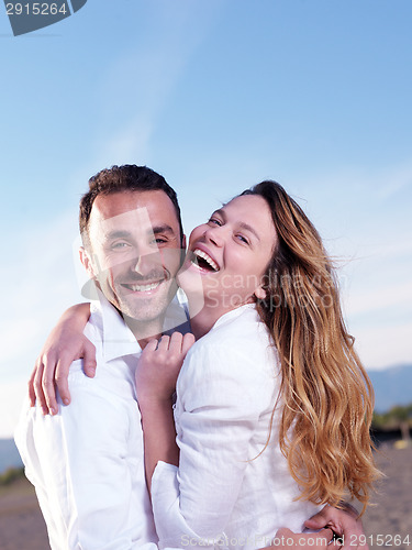 Image of young couple  on beach have fun