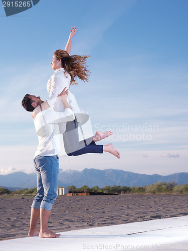 Image of young couple  on beach have fun
