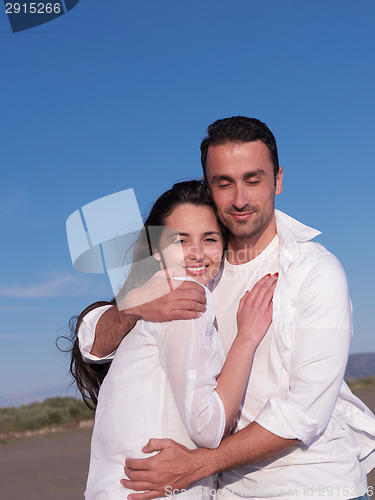 Image of young couple  on beach have fun
