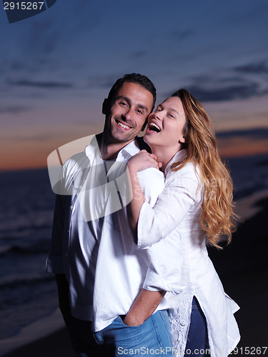 Image of young couple  on beach have fun