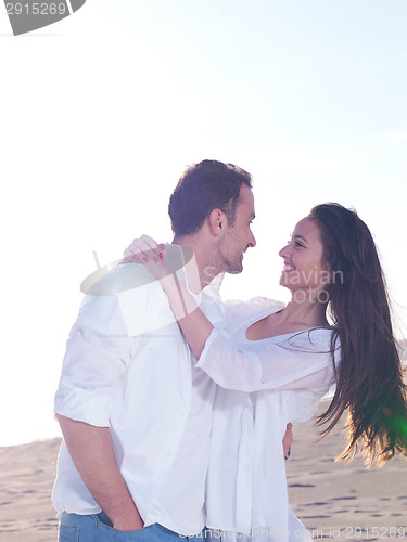 Image of young couple  on beach have fun