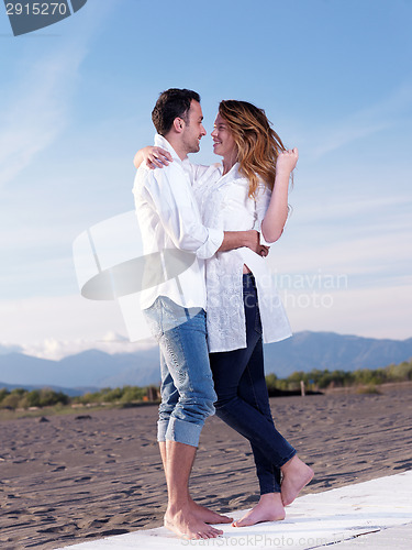 Image of young couple  on beach have fun