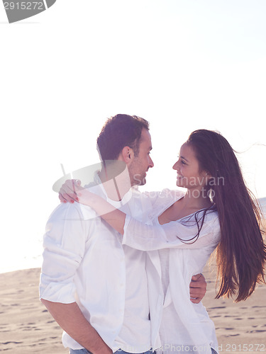 Image of young couple  on beach have fun