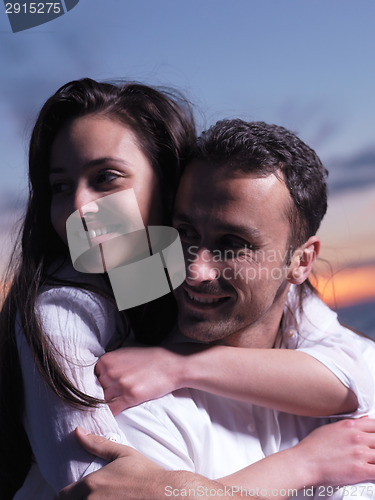 Image of young couple  on beach have fun