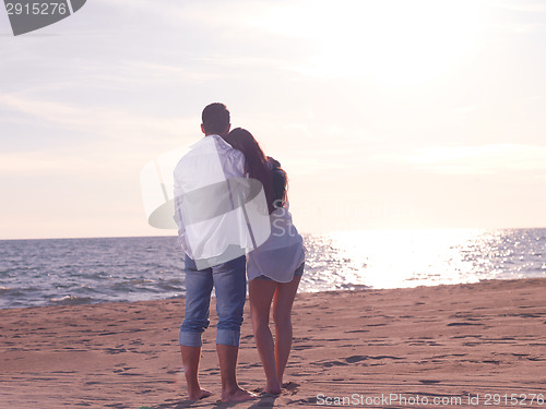 Image of young couple  on beach have fun