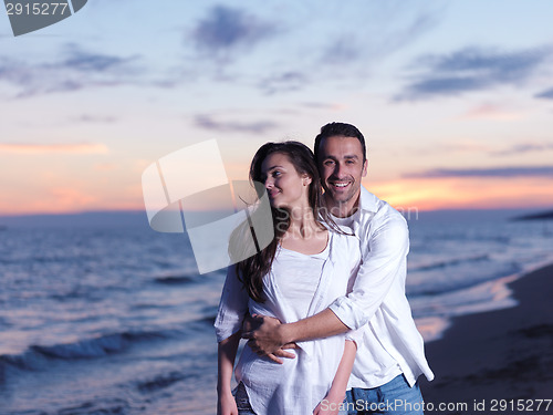 Image of young couple  on beach have fun
