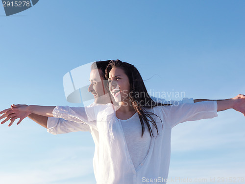 Image of young couple  on beach have fun