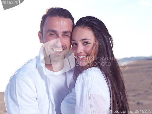 Image of young couple  on beach have fun