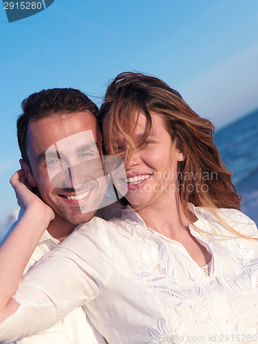 Image of young couple  on beach have fun