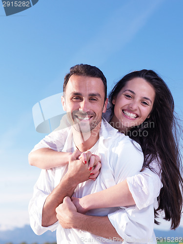 Image of young couple  on beach have fun