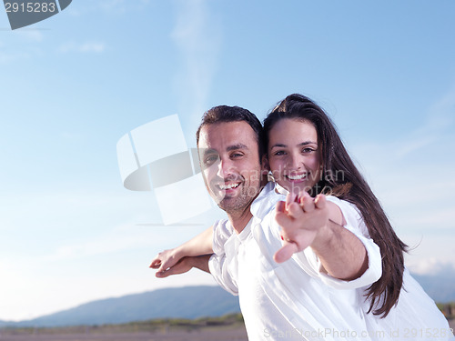 Image of young couple  on beach have fun