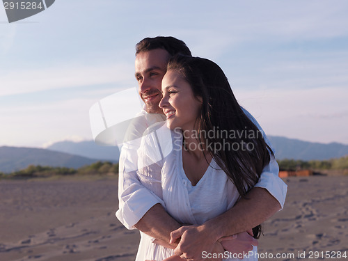 Image of young couple  on beach have fun