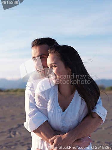 Image of young couple  on beach have fun