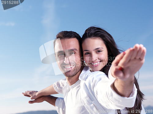 Image of young couple  on beach have fun