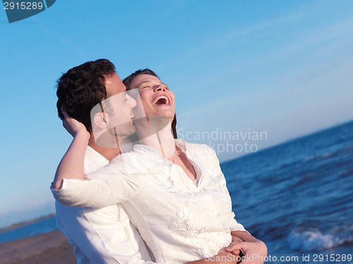 Image of young couple  on beach have fun