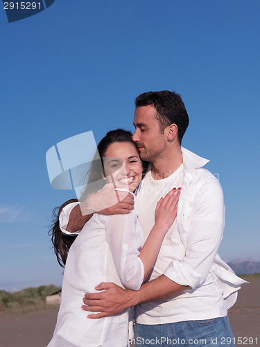 Image of young couple  on beach have fun