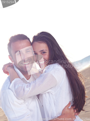 Image of young couple  on beach have fun