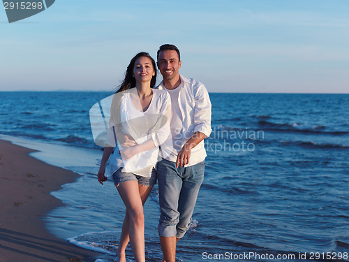 Image of young couple  on beach have fun