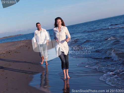 Image of young couple  on beach have fun